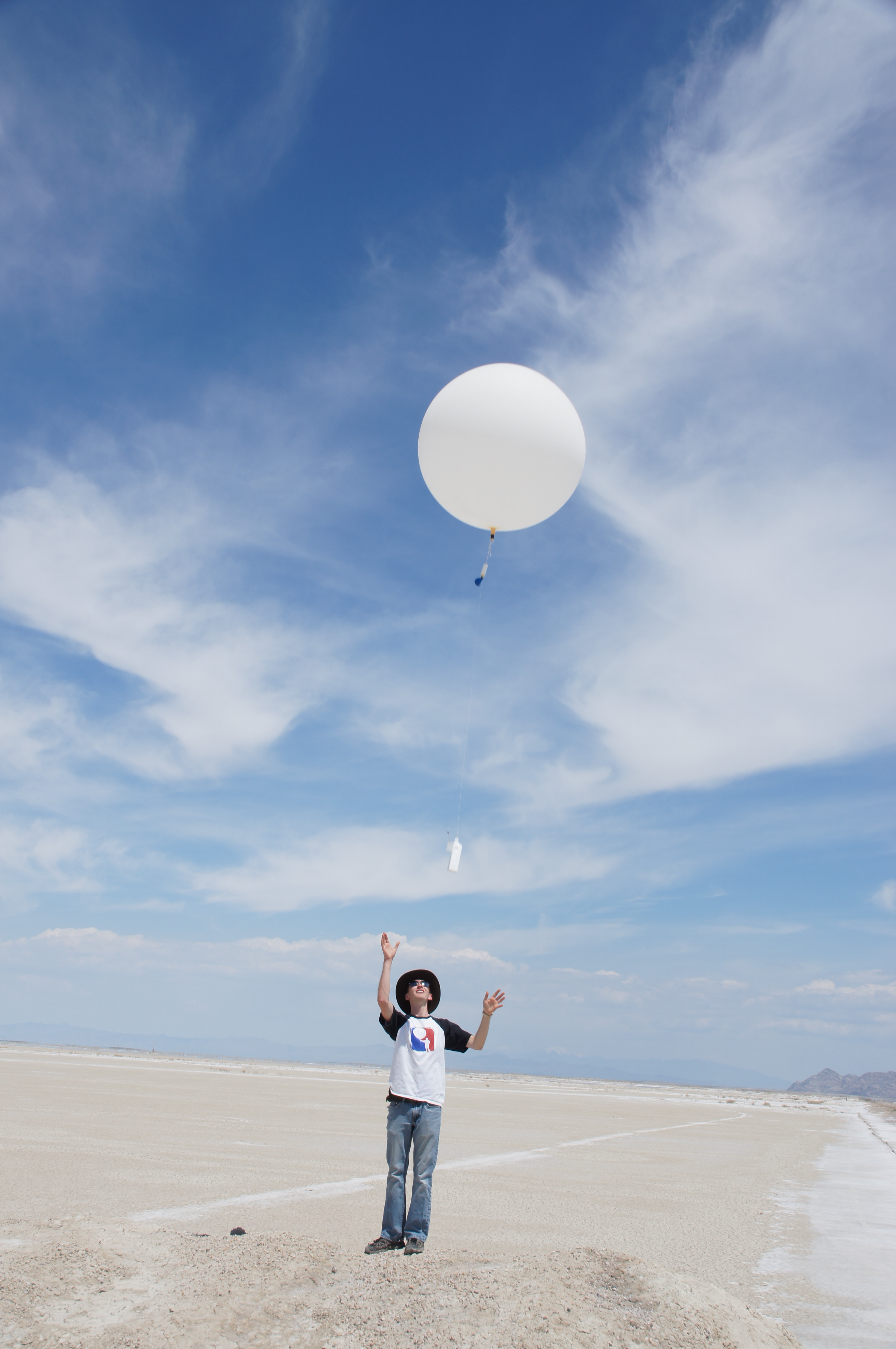 Graduate student launching weather ballooon during field experiement